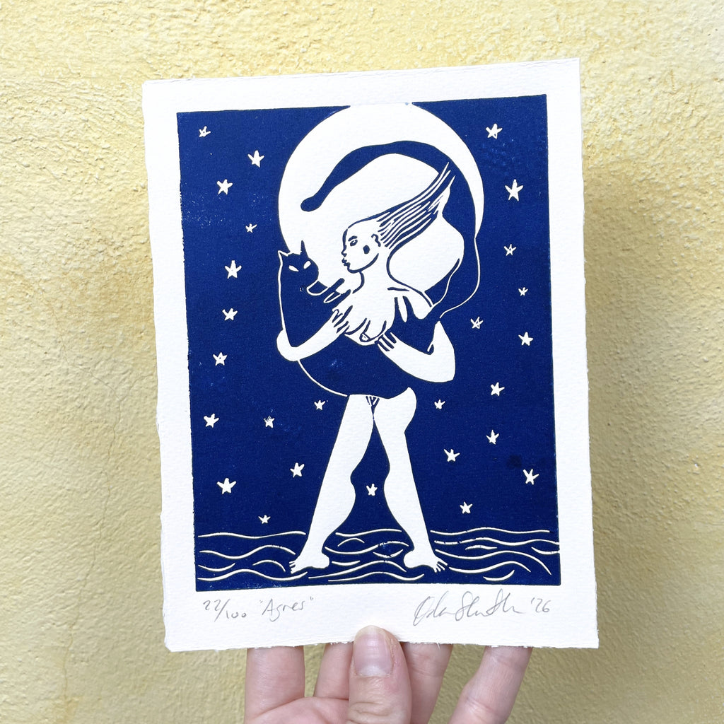 Blue figurative linocut "Agnes", a woman holding a cat with the moon behind them
