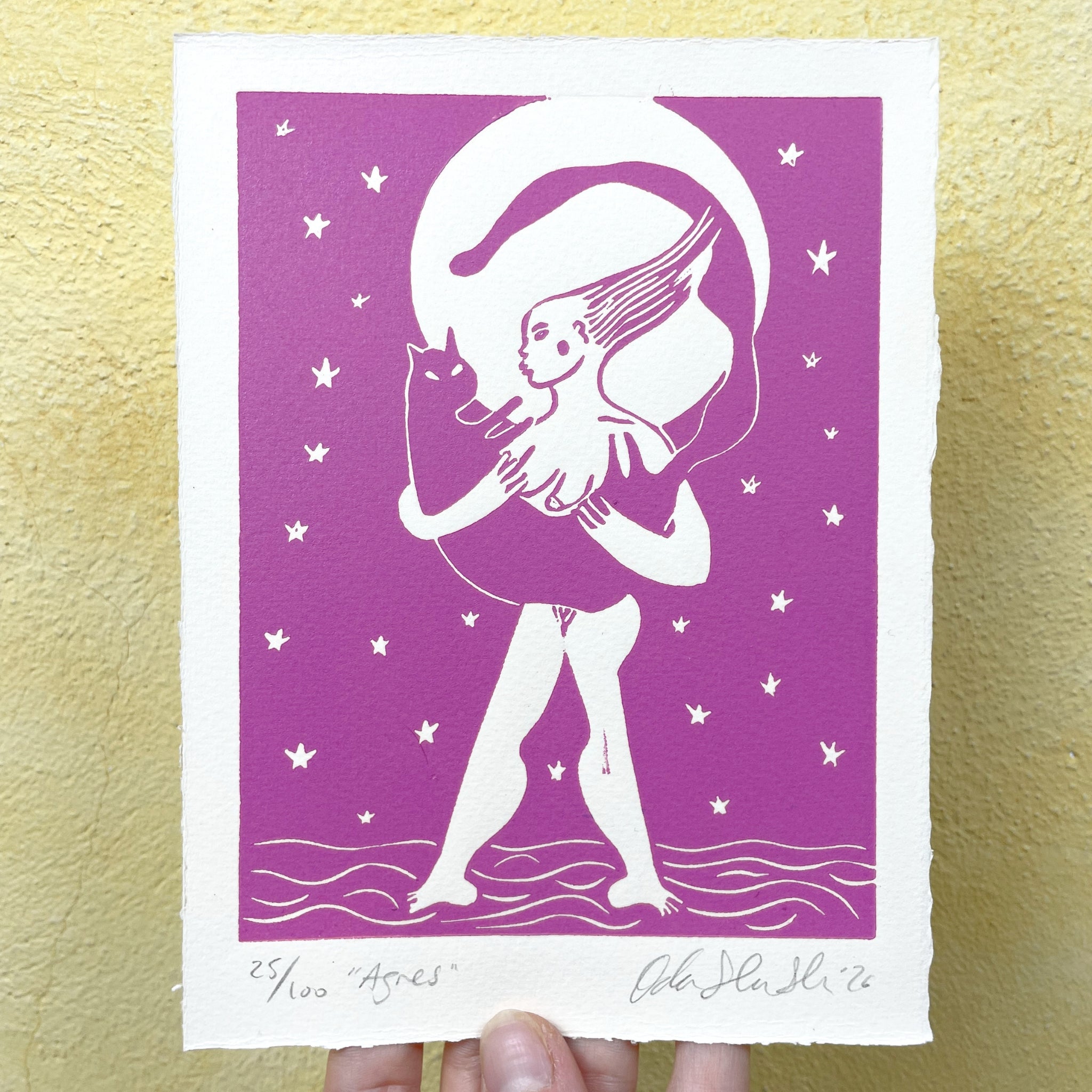 Pink figurative linocut "Agnes", a woman holding a cat with the moon behind them
