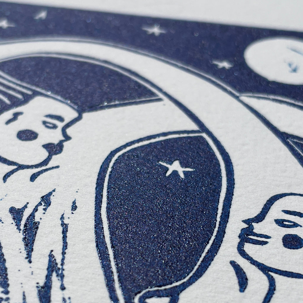 Close-up of a blue and white illustration with abstract shapes and faces.