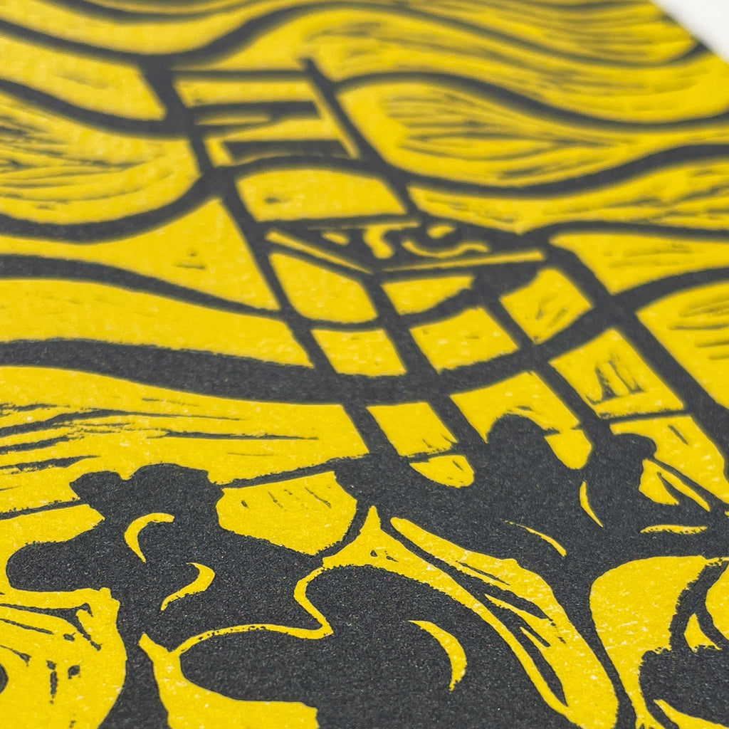 Close-up of a yellow and black patterned surface with abstract shapes