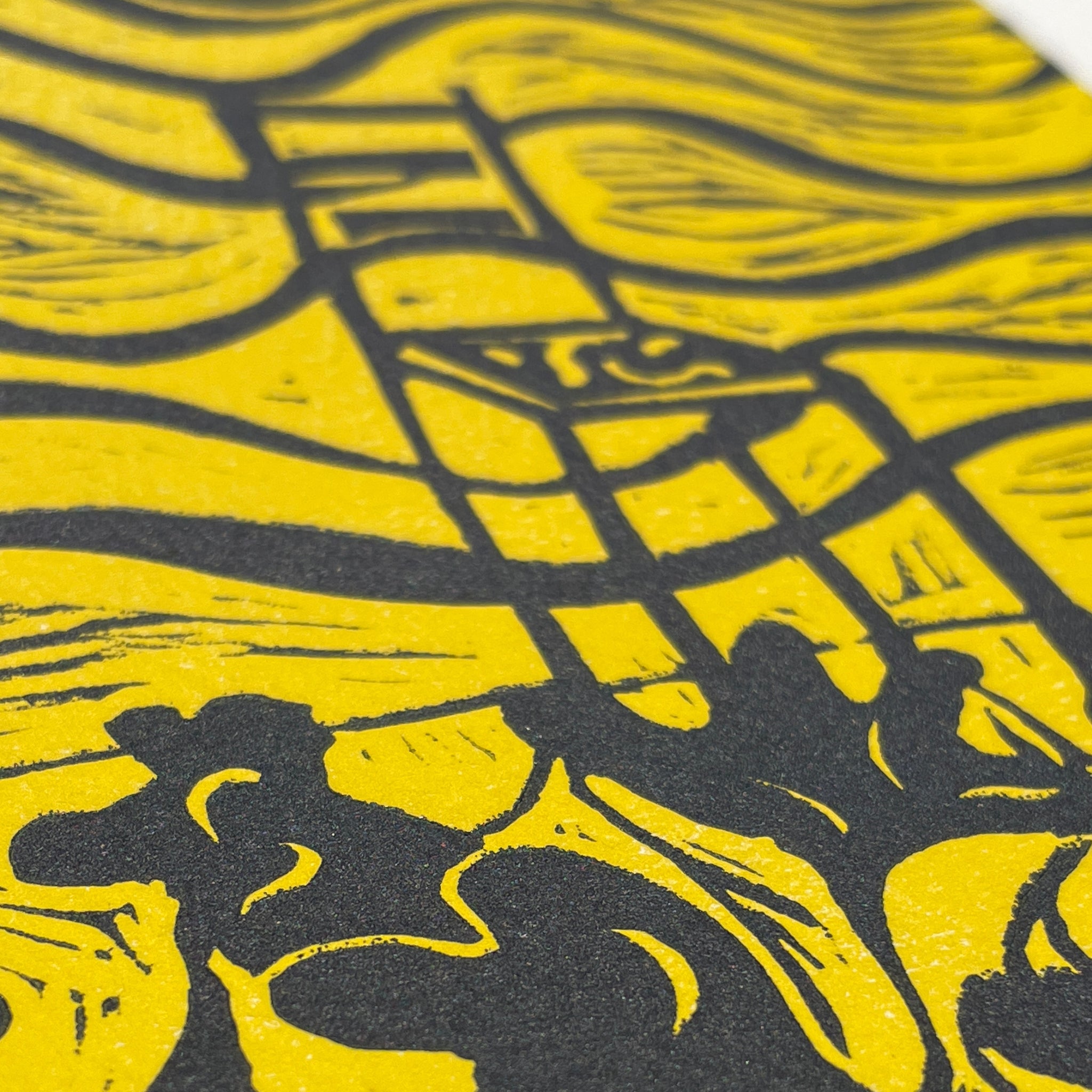Close-up of a yellow and black patterned surface with abstract shapes
