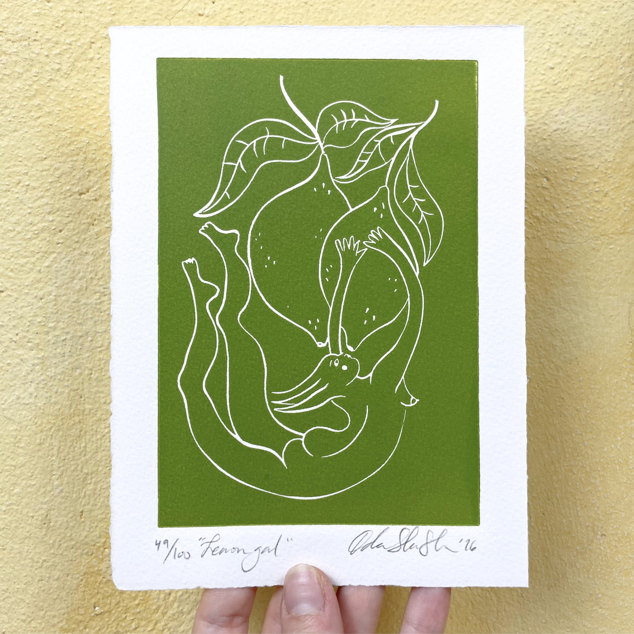 Green botanical style  linocut "Lemon Gal", a fairy-like woman draped among lemons on a tree