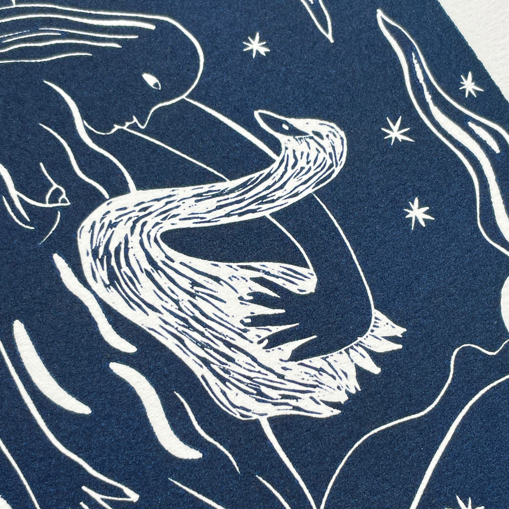 Blue linocut print of a swan with stars