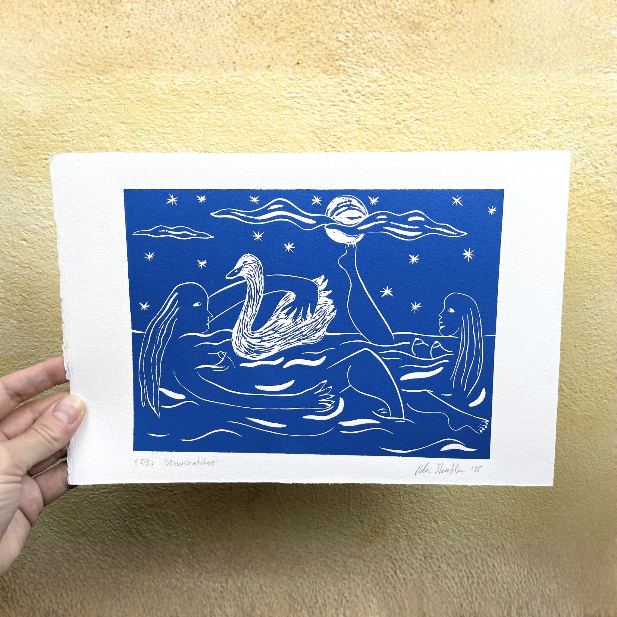 Blue and white illustration of a women and swans held against a beige background