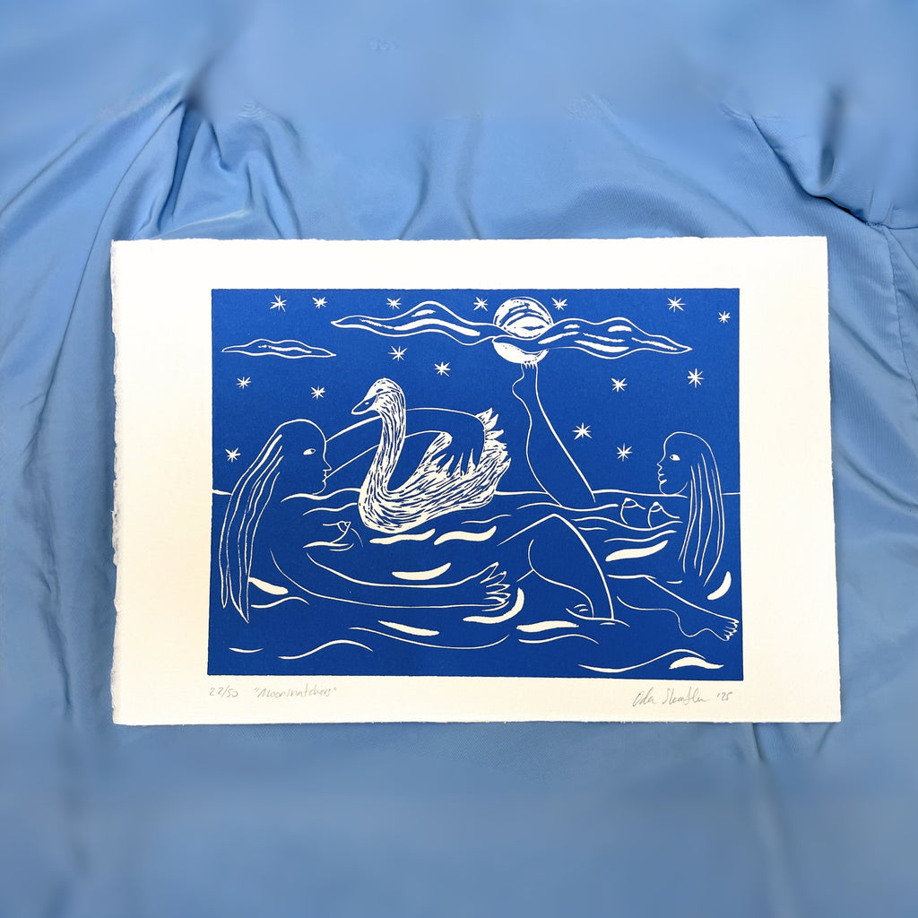 Art print of women, swans and a moon on a blue fabric background