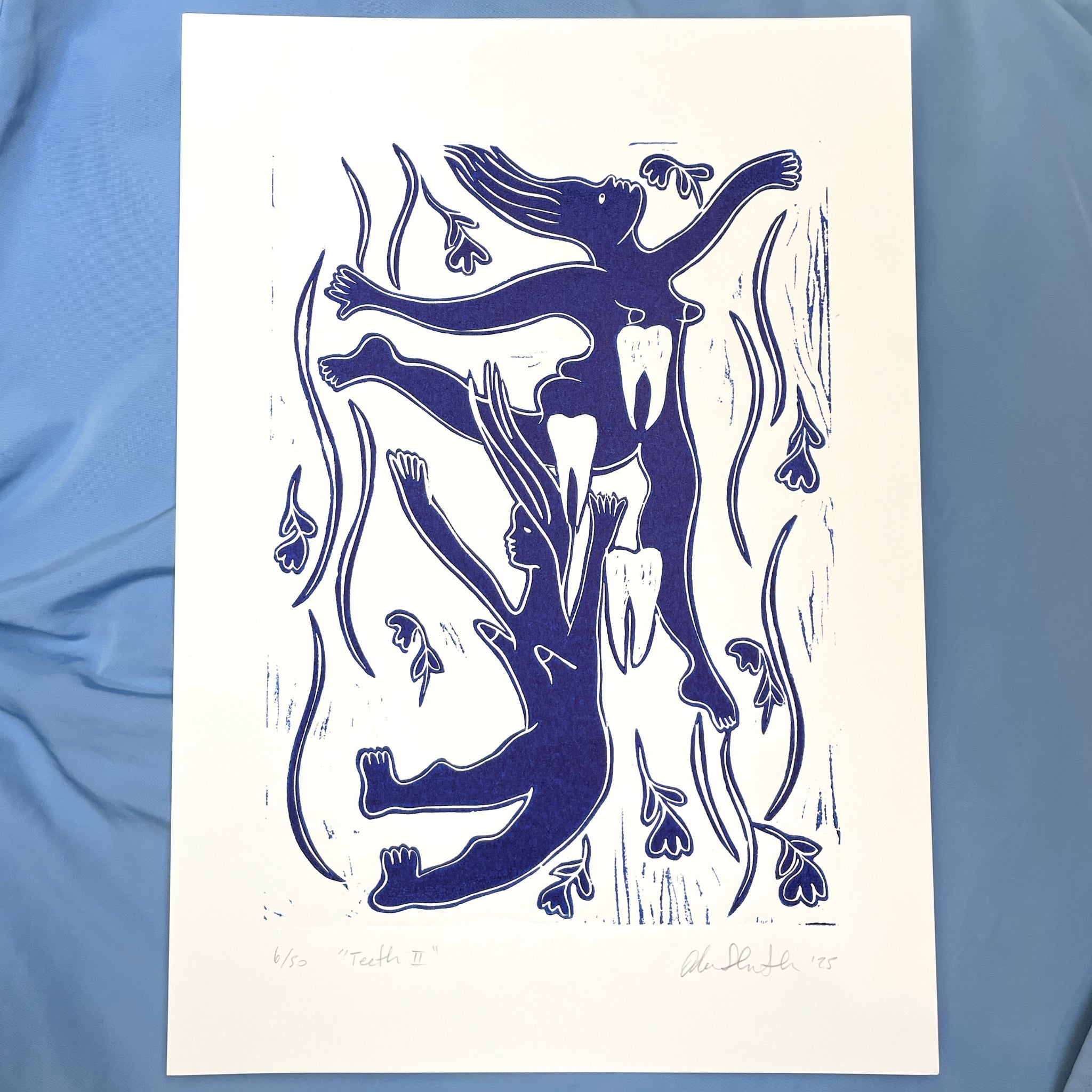 Blue figurative linocut "Teeth II" with falling women surrounded by teeth and falling flowers
