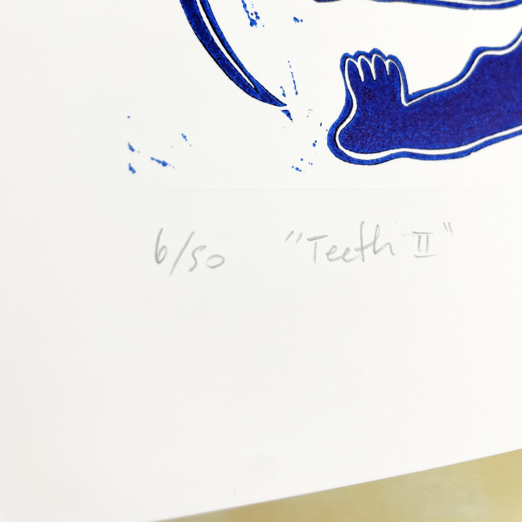 Blue abstract design on a white background with text '6/50' and 'Teeth II'.