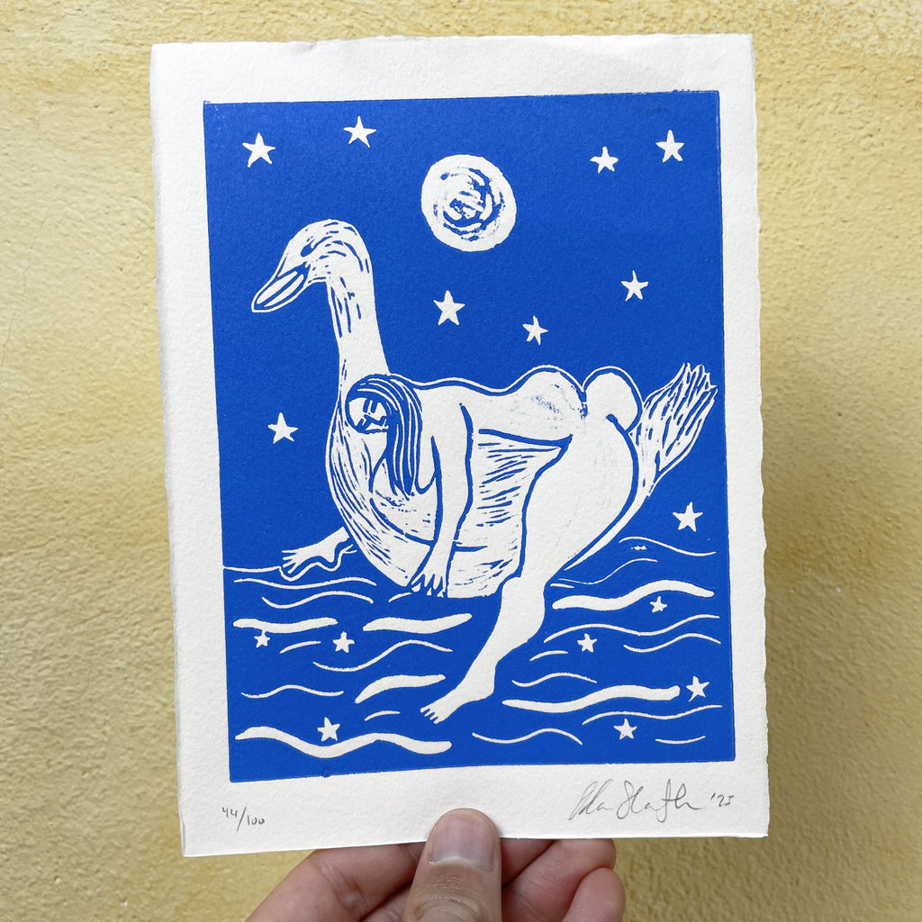 Blue linocut "Tender", a woman drifting on a lake carried by a duck beneath the moon
